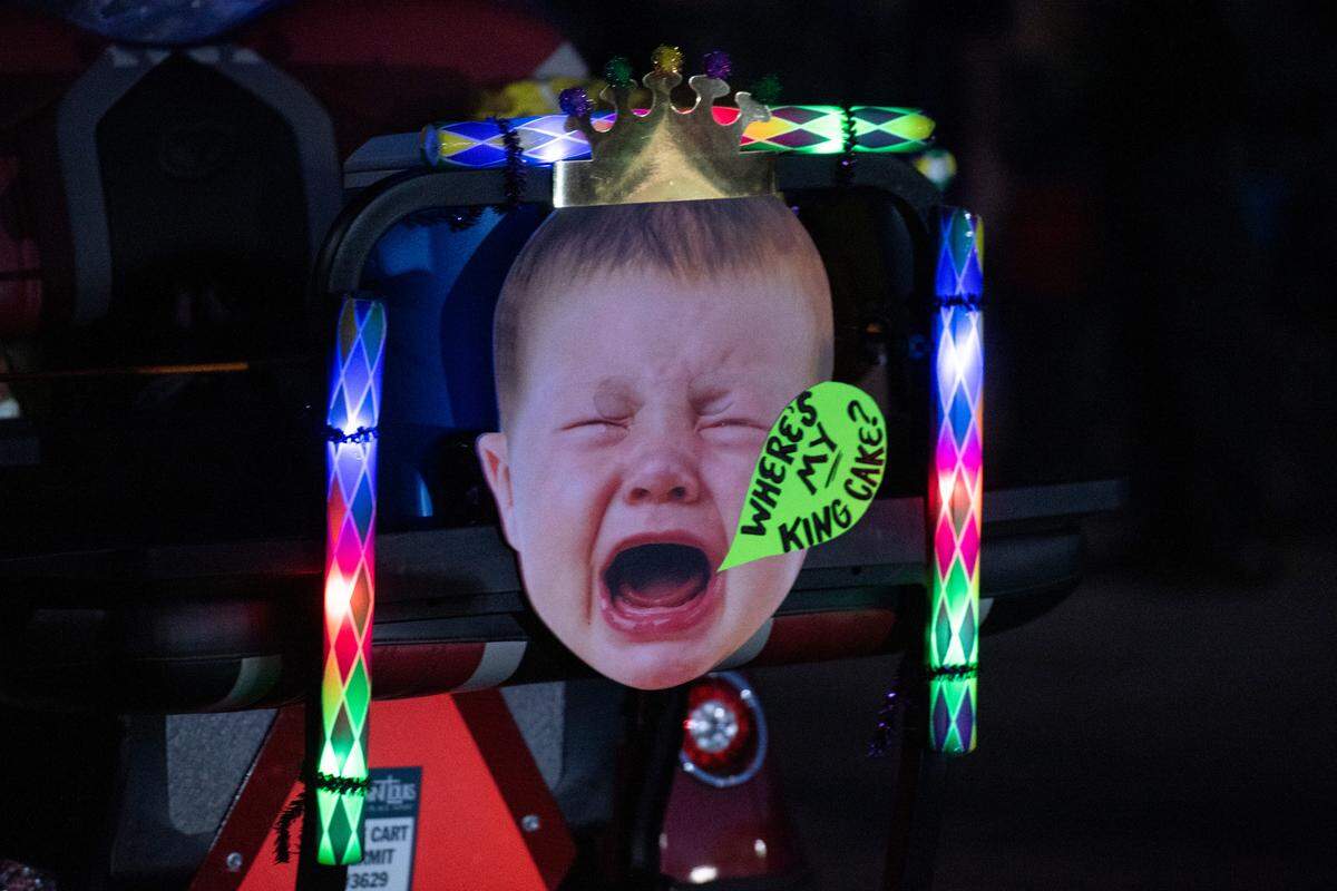 A sign on a float references king cake in Mystic Krewe of the Seahorse’s Lundi Gras parade in Bay St. Louis on Monday, March 3, 2025.