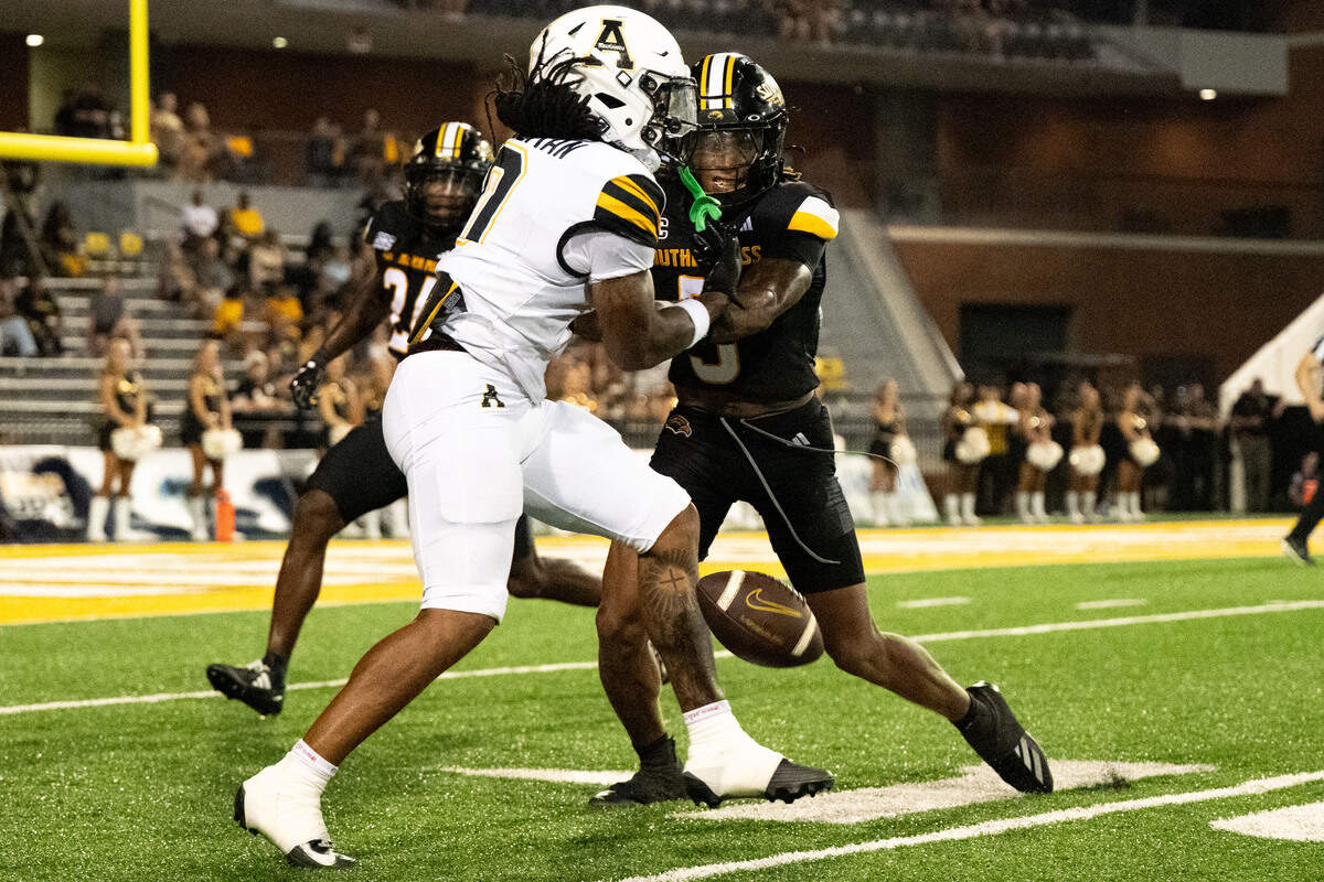 Southern Miss safety Ian Foster (3) breaks up a pass intended for Appalachian State wideout Doopah Coleman (0).