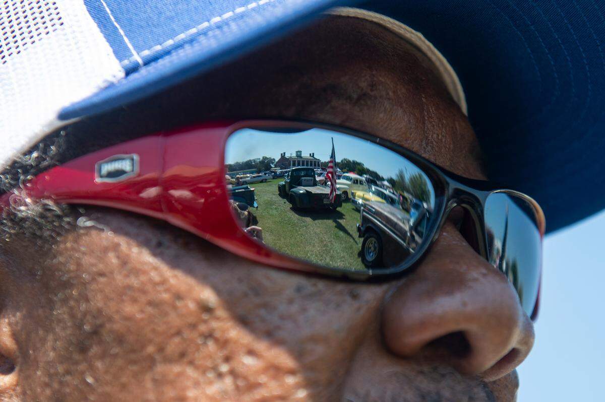 Cars are reflected in Robert Robinson’s glasses at Cruisin’ The River City in Moss Point during Cruisin’ The Coast on Tuesday, Oct. 8, 2024.