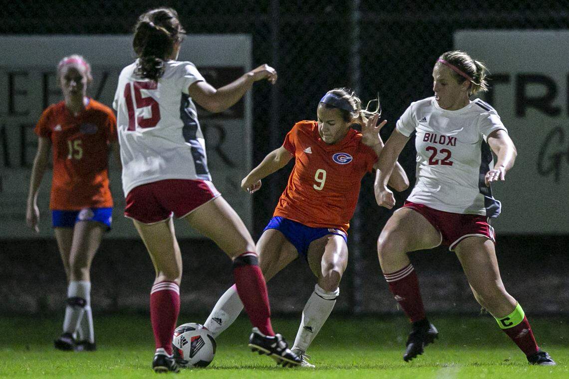 Kate Smith, center, kicks the ball away during a game against Biloxi at Herbert Wilson Recreation Center in Gulfport on Tuesday, Dec. 14, 2021.