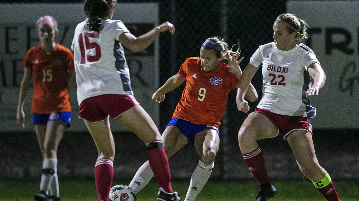 Kate Smith, center, kicks the ball away during a game against Biloxi at Herbert Wilson Recreation Center in Gulfport on Tuesday, Dec. 14, 2021.