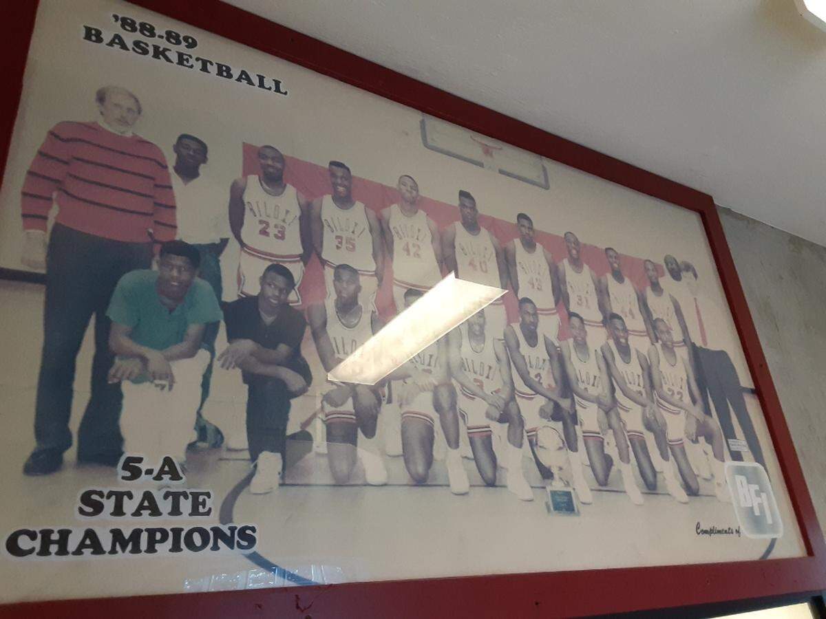 Reginald Johnson, in the blue shirt on the left, was the manager of the boys’ basketball team at Biloxi High School when the team won state championships in 1989 and 1990.