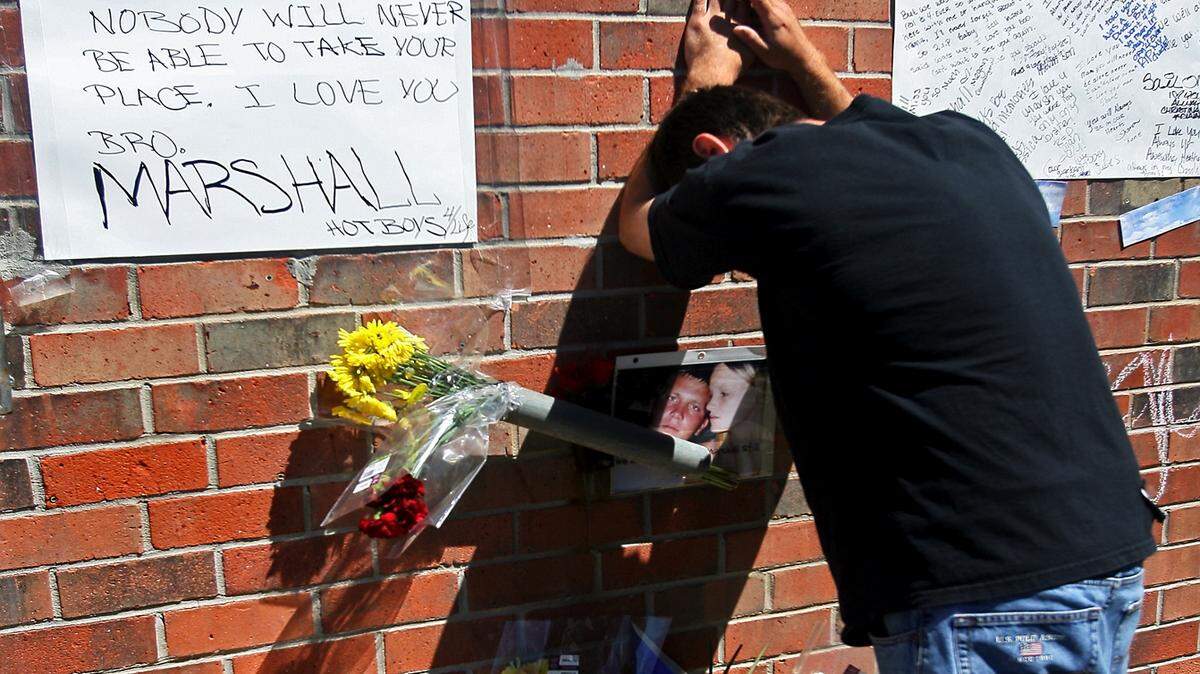 AMANDA McCOY/SUN HERALD 2009Korry Breland grieves for the loss of his friend, Marshall Still, at a makeshift memorial created at Snappy Car Wash on Pass Road where Still was found shot to death in April 2013. MIchael Ambrose was convicted of Still's murder. DeShawn Brown, who had been with them, is serving time on lesser convictions.
