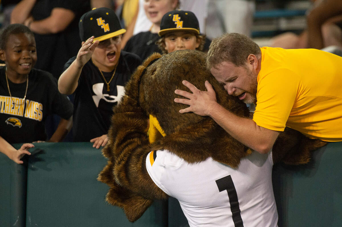 A fan hugs the Southern Miss Golden Eagles mascot during a game at Yulman Stadium in New Orleans on Saturday, Sept. 24, 2022.