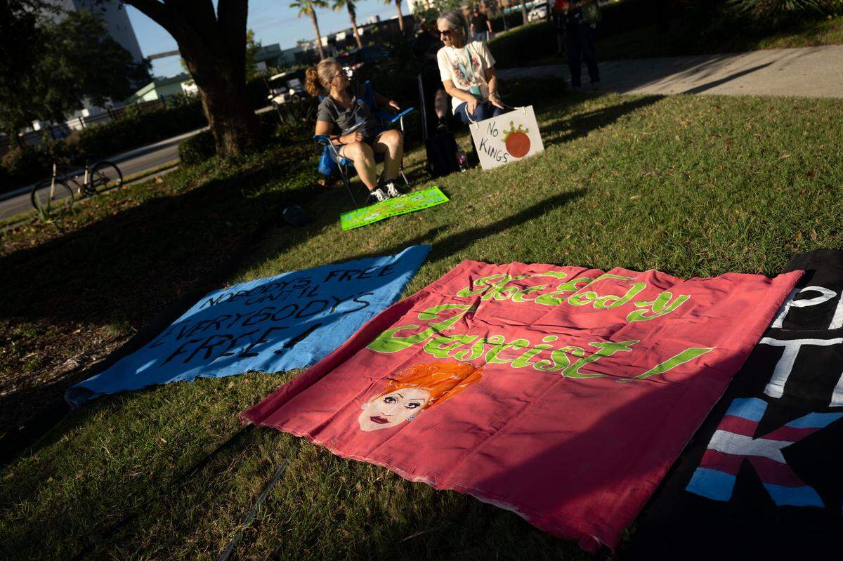 Signs and banners lay on the ground Saturday during the Gulfport No Kings protest.