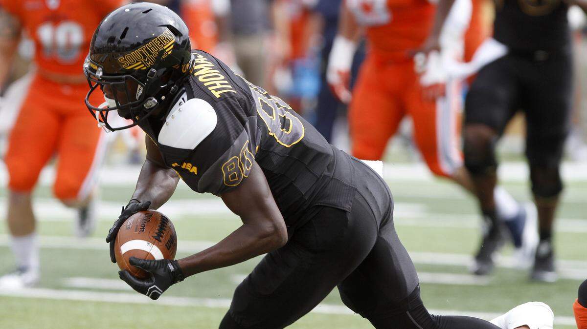 TIM ISBELL/SUN HERALDSouthern Miss receiver Mike Thomas escapes a UTEP tackle to dive for a touchdown on Halloween.