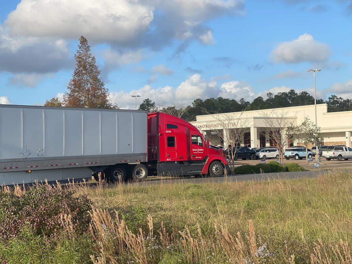An 18-wheeler temporarily blocked Touriel Road, just south of the busy voting precinct at the Lyman Community Center in Gulfport (background). A tow truck lifted the rear wheels of the 18-wheeler from a ditch, freeing the driver to continue his route and unblocking one of the northbound lanes of U.S. 49, which runs in front of the center.