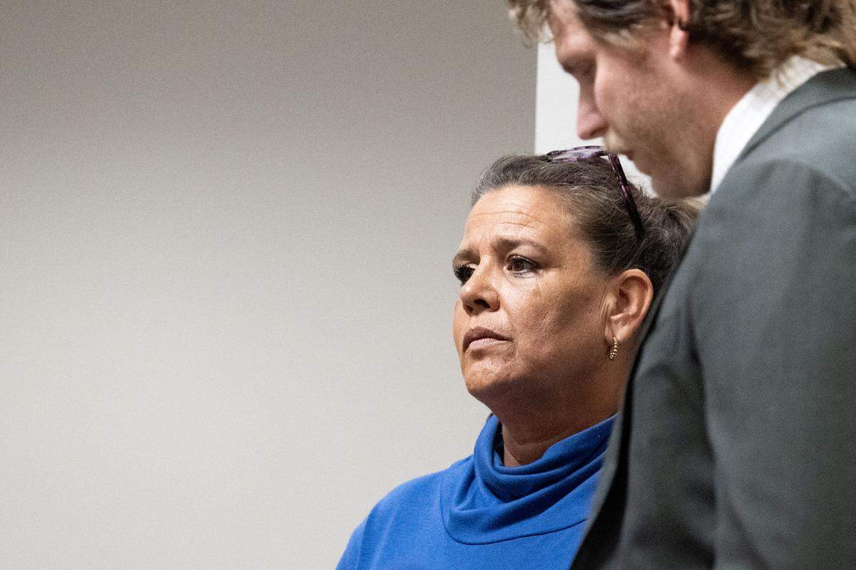 Kasi McDaniel stands Wednesday with her attorney, Cameron McCormick, during her sentencing for embezzling over $25,000.