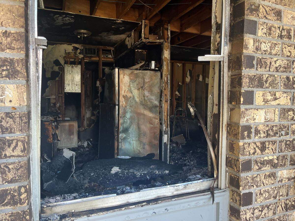 A view through a window of a damaged apartment shows the effects of Tuesday’s fire at Sugar Mill Apartments in Gulfport.