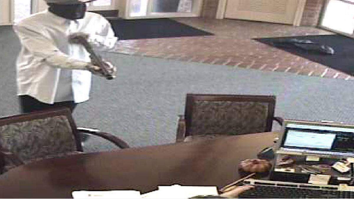 BILOXI POLICE DEPARTMENT/2013 
 
 A man with a sawed-off shotgun is shown robbing The First bank on Pass and Big Lake roads in Biloxi in October 2013. Federal law prohibits private citizens from having a sawed-off shotgun unless the owner passes a background check and the weapon is registered with the Bureau of Alcohol, Tobacco, Firearms and Explosives.