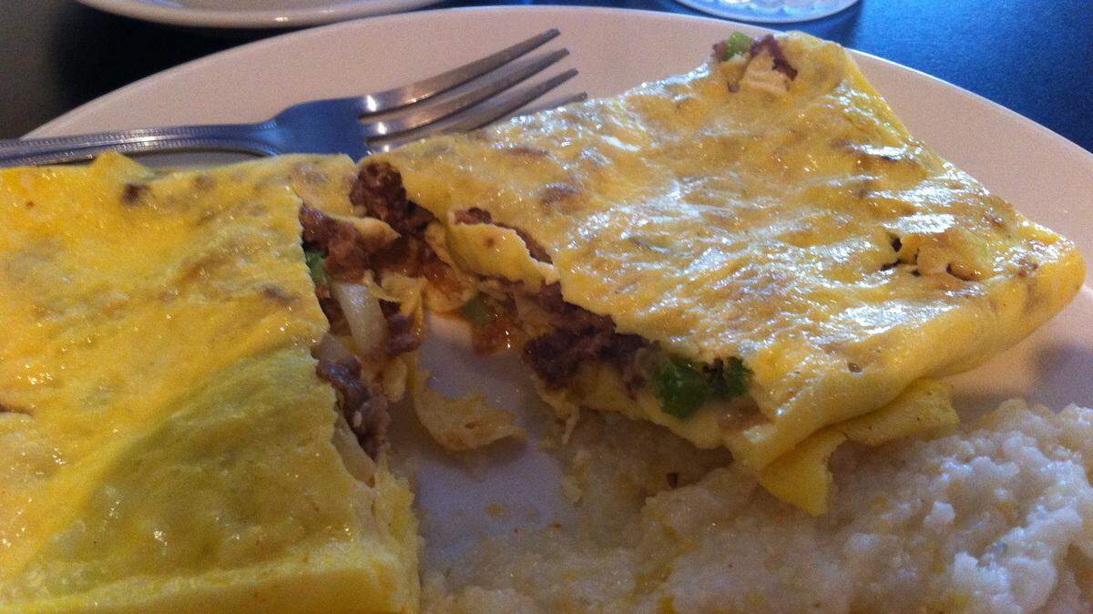 TAMMY SMITH/SUN HERALDA Philly omelet is served with grits at Sunrise Café in Bay St. Louis.