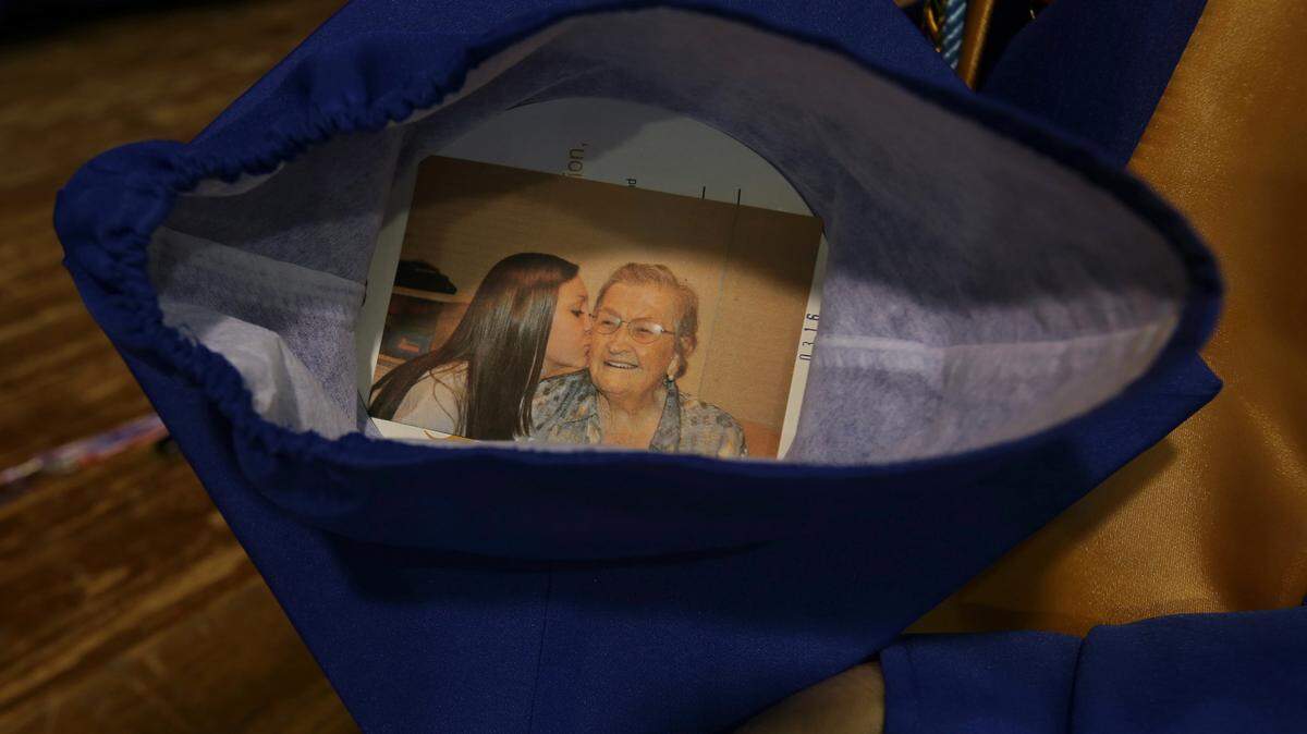 AMANDA McCOY/SUN HERALD 
 Jadyn Saucier put a photo of herself and her grandmother, Luby Peterson, inside of her cap for Hancock High's graduation on Thursday, May 19, 2016.