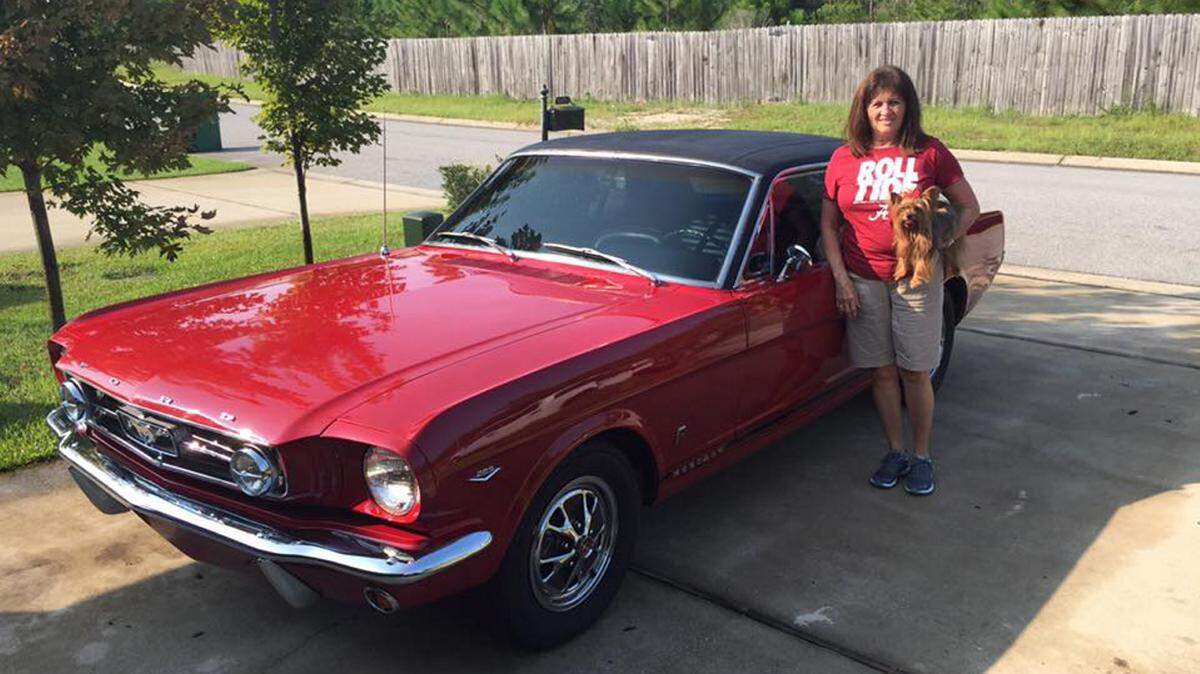 COURTESY TERRY BARFIELD 
 Scotty Barfield next to her '65 Mustang