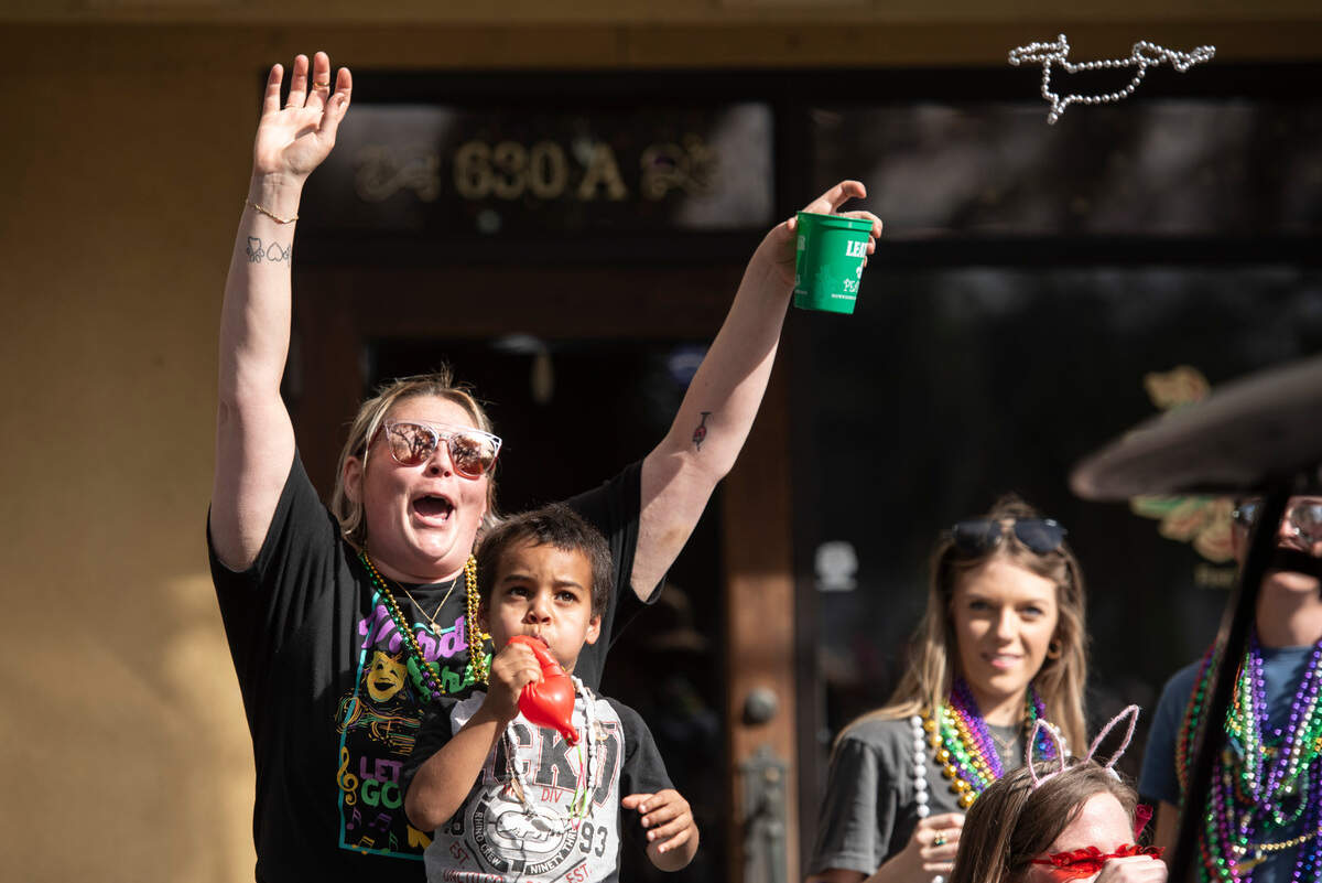Parade watchers cheer for throws during the Ocean Springs Elks Club Mardi Gras Parade in Ocean Springs on Saturday, Feb. 15, 2025.