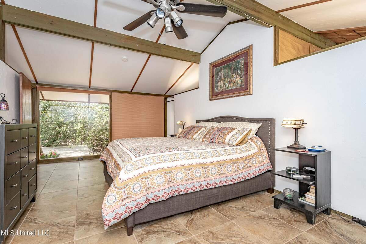 The primary bedroom in this issue house for sale on Nelson Road in Ocean Springs features a plate-glass window that lets in plenty of light.