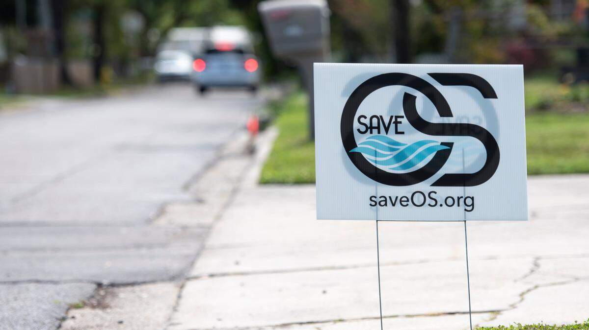 A SaveOS sign in a yard on Bowen Avenue in Ocean Springs on Thursday, April 11, 2024. The SaveOS campaign aims to protect the city from uncontrolled growth and opposes a marina on Front Beach.