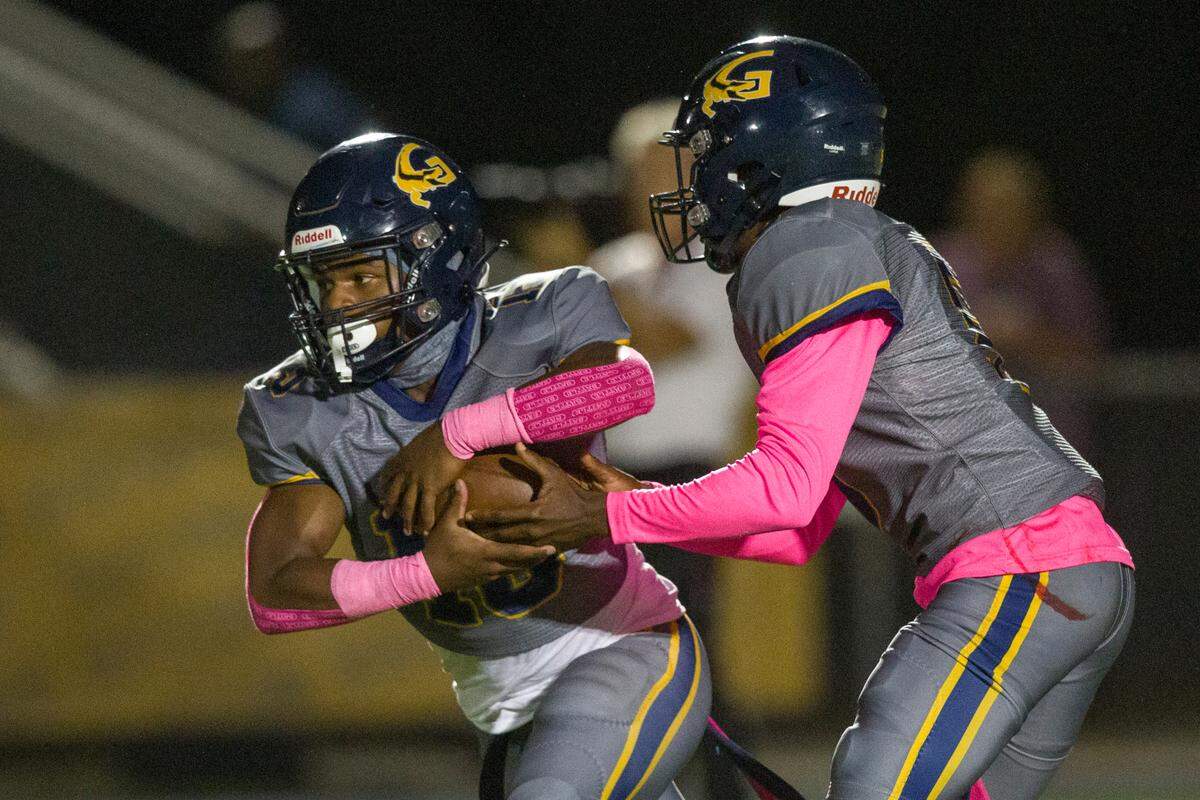 Gautier quarterback Kelvin Beavers hands a pass off to Solomon Baggett during a game against East Central at Gautier High School in Gautier on Friday, Oct. 20, 2023.