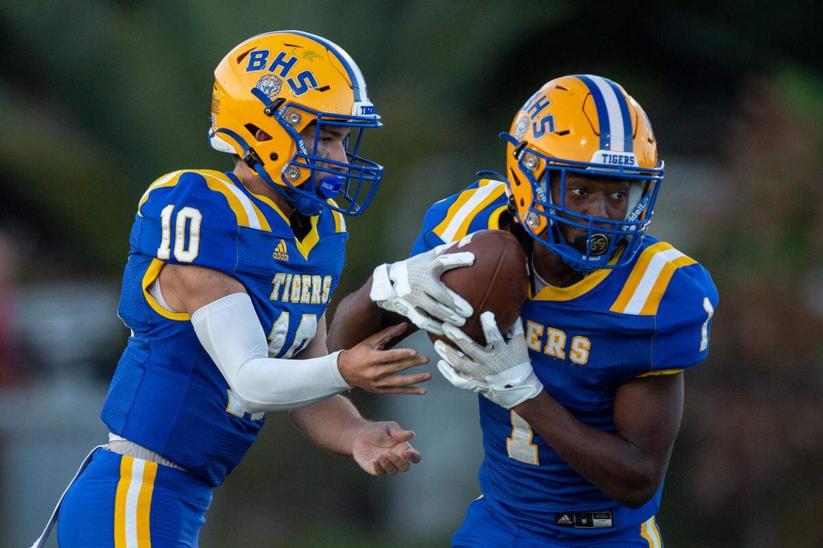 Bay High quarterback Xander Ladner passes the ball off to Jaylen Antoine during a game against St. Stanislaus at Bay High in Bay St. Louis on Friday, Sept. 1, 2023.