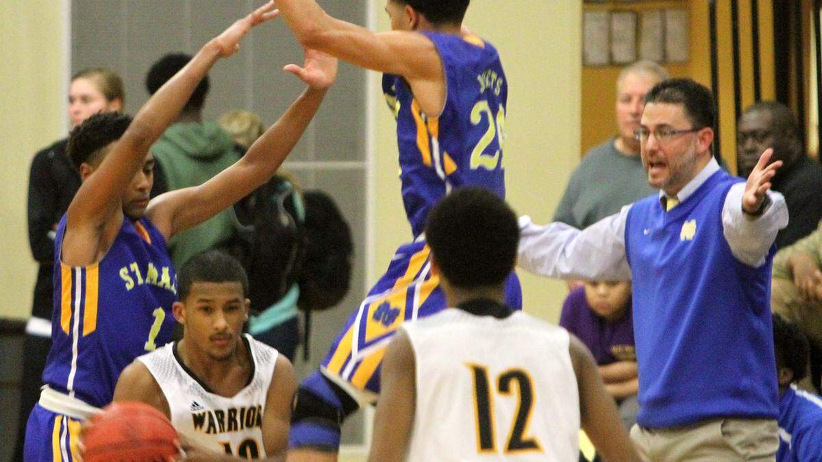 JOHN FITZHUGH/SUN HERALD 
 D'Ibervville's Nick Jenkins finds a pass against the St. Martin defense during the first half of their game at D'Iberville on Friday Jan. 8, 2016.