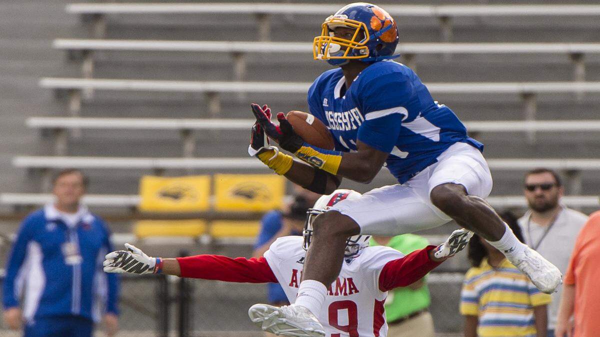 VASHA HUNT/AL.COM 
 Mississippi's DeKaylin 'D.K.'Metcalf grabs a pass over Alabama' Brandon Alexander during the annual Mississippi/Alabama All-Star Classic Saturday at Southern Miss' M. M. Roberts Stadium in Hattiesburg.
