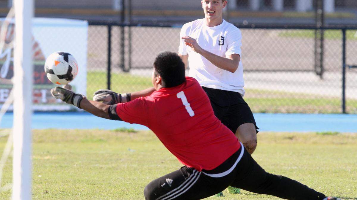JOHN FITZHUGH/SUN HERALD 
 St. Stanislaus striker Corbin Blanchard puts a shot past Clinton goalie Cesar Camacho to give the Rocks a 2-0 lead in the second half of their game at Milner Stadium in Gulfport on Saturday Jan. 9, 2015.
