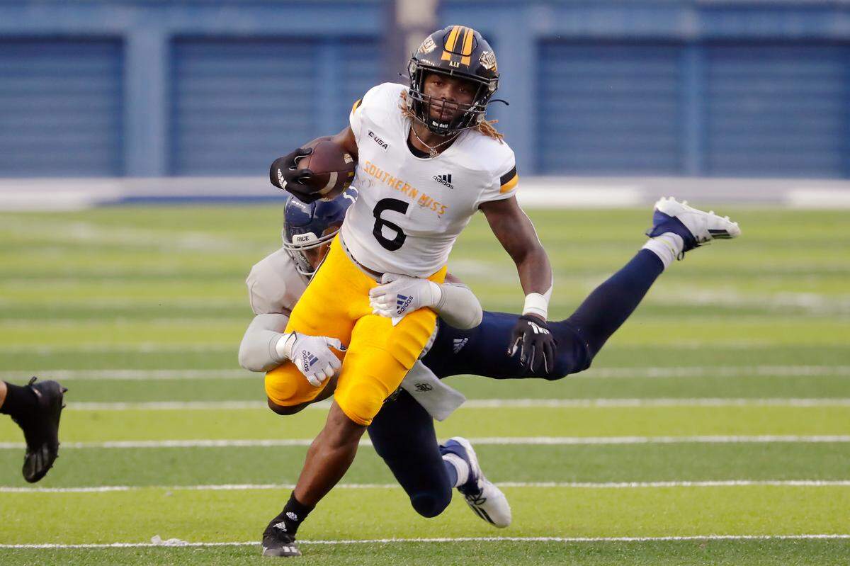 Southern Mississippi running back Dajon Richard (6) breaks the tackle attempt by Rice linebacker Myron Morrison, left, during the first half of an NCAA college football game Saturday, Oct. 2, 2021, in Houston, Texas. (AP Photo/Michael Wyke)