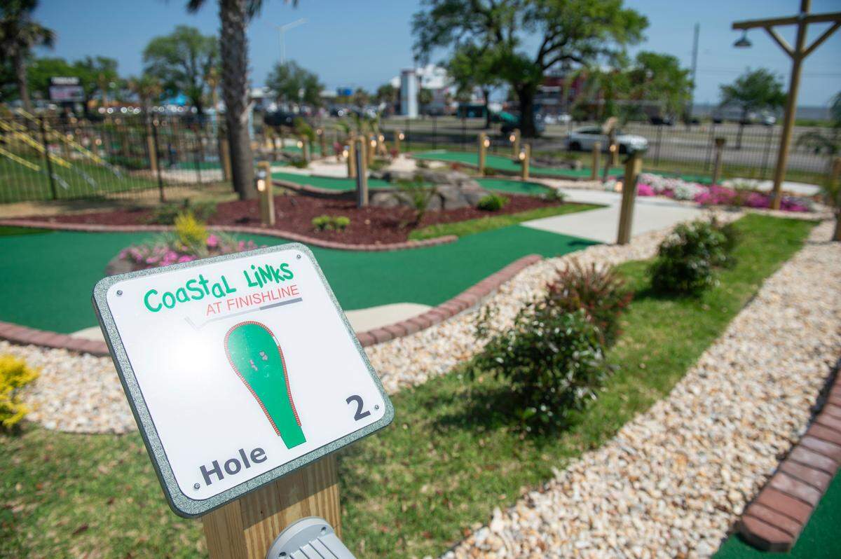 The new Coastal Links mini golf course at Finishline Performance Karting in Biloxi is tucked between one of the kart tracks and Beach Boulevard and beneath the zipline tower.