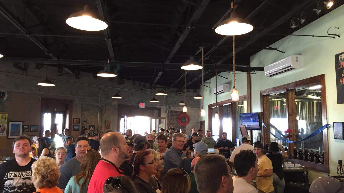 NATE THURMAN/SUN HERALDPeople wait in line for beer at Chandeleur Brewing Co. in Gulfport on Saturday.