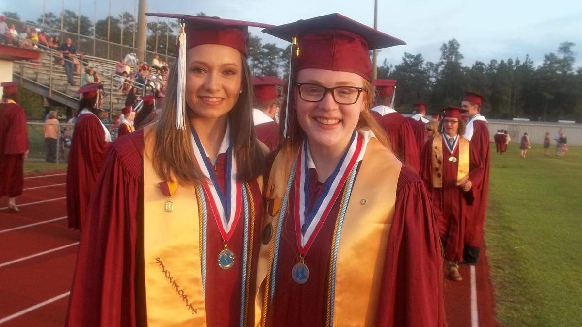 VETO ROLEY/SPECIAL TO THE SUN HERALD 
 George County High salutatorian Megan Staffieri, left, and valedictorian Emily Cates pause before the graduation ceremony on Friday night, May 20, 2016, in Lucedale.