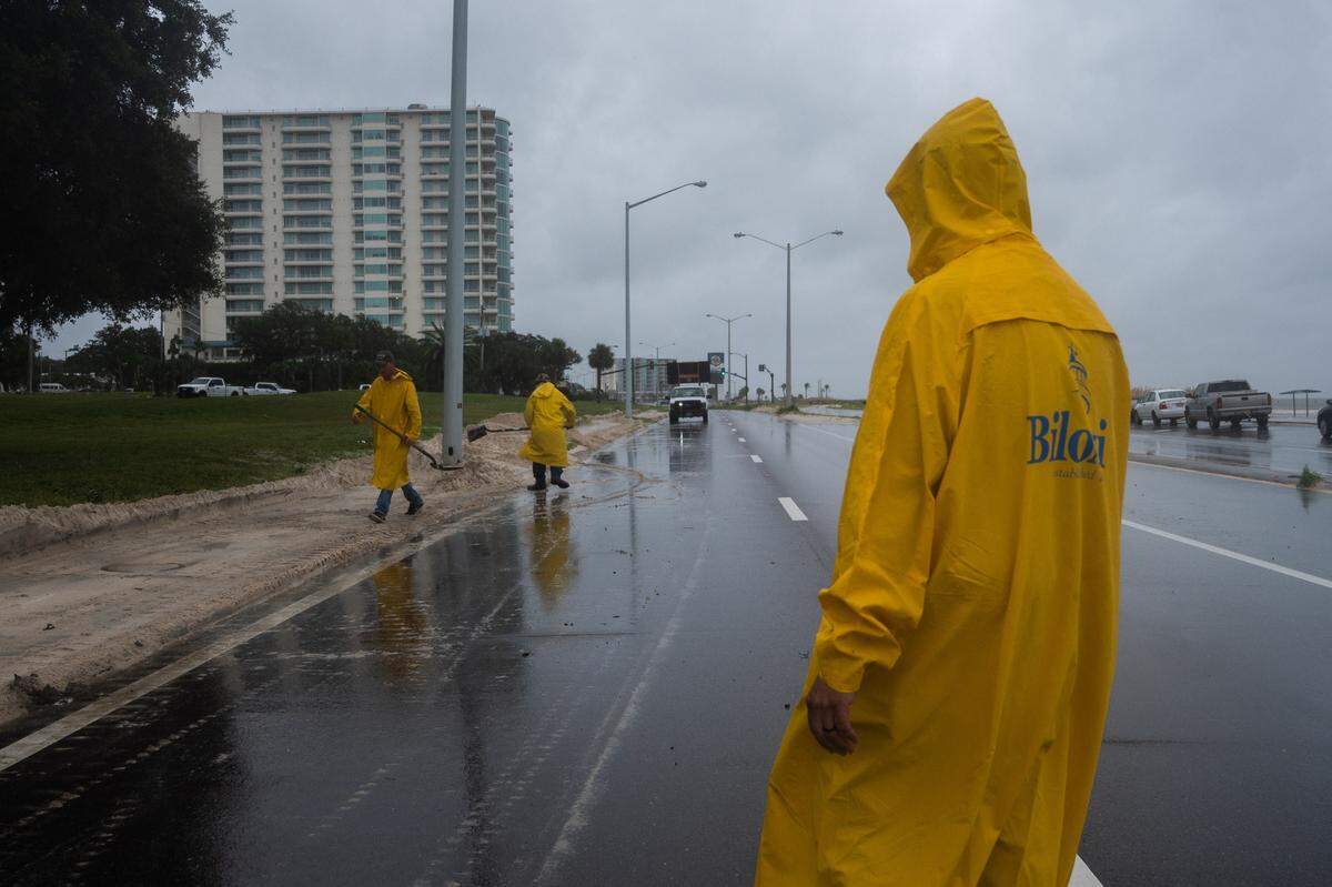 City of Biloxi work crews clean off sand from Highway 90 in Biloxi, Mississippi, on Tuesday, Sept. 15, 2020.