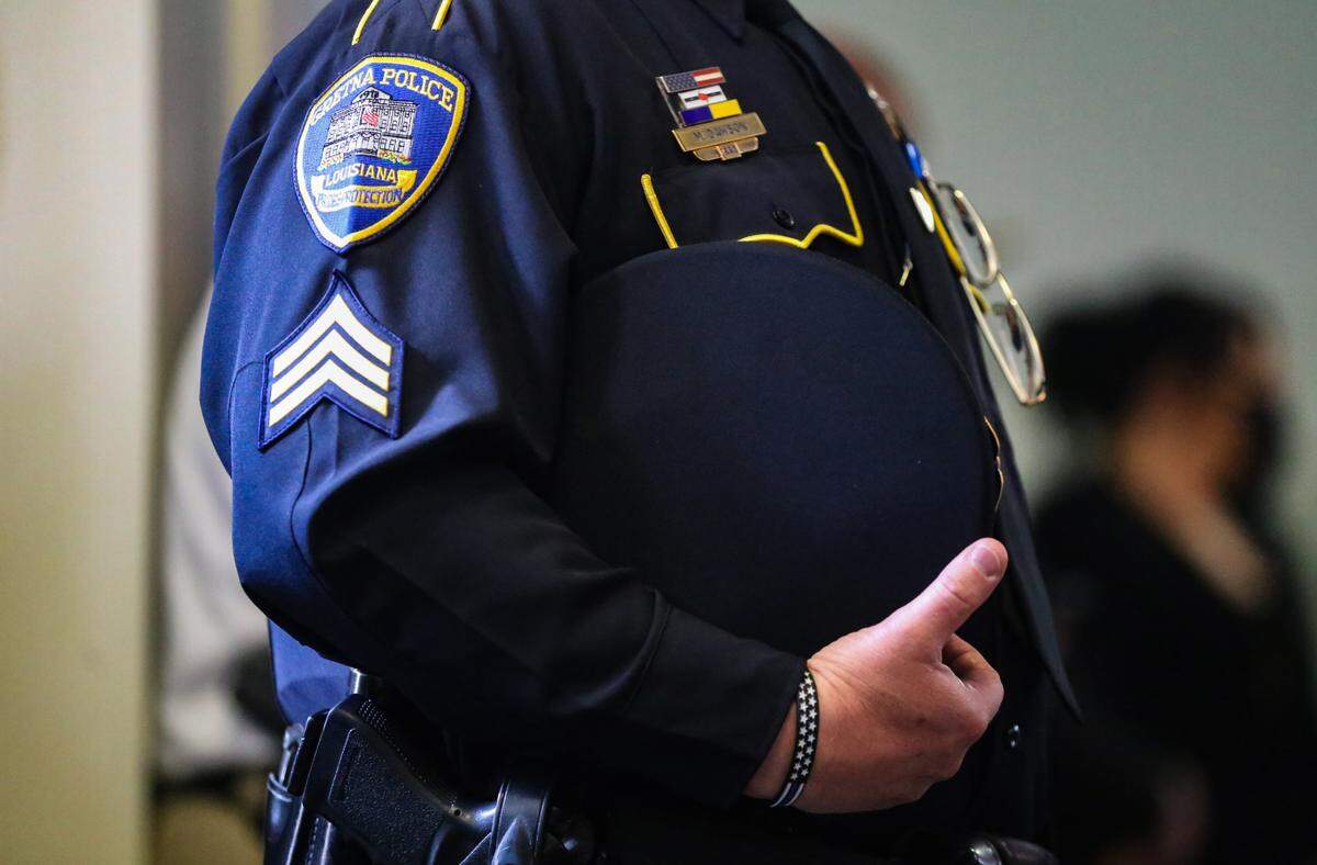 A Gretna, Louisiana police officer stands during the funeral of fallen Hancock County Deputy Lt. Michael Boutte Tuesday, February 9, 2021 in Bay St. Louis, Mississippi.
