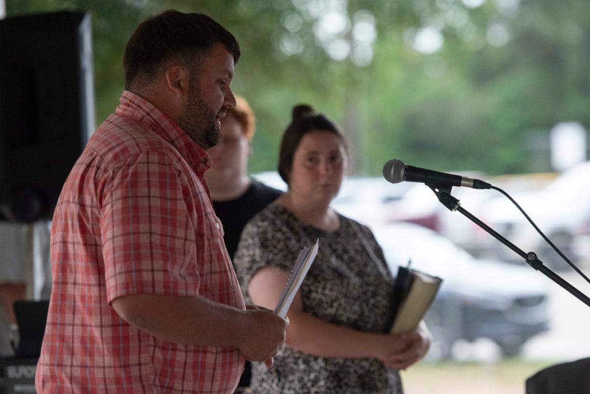 Pastor Zack Coulter of Persimmon Hill Baptist Church gives a sermon during a candlelight vigil in remembrance of Gracelynn Vick at Saucier Park on Tuesday, April 22, 2025.