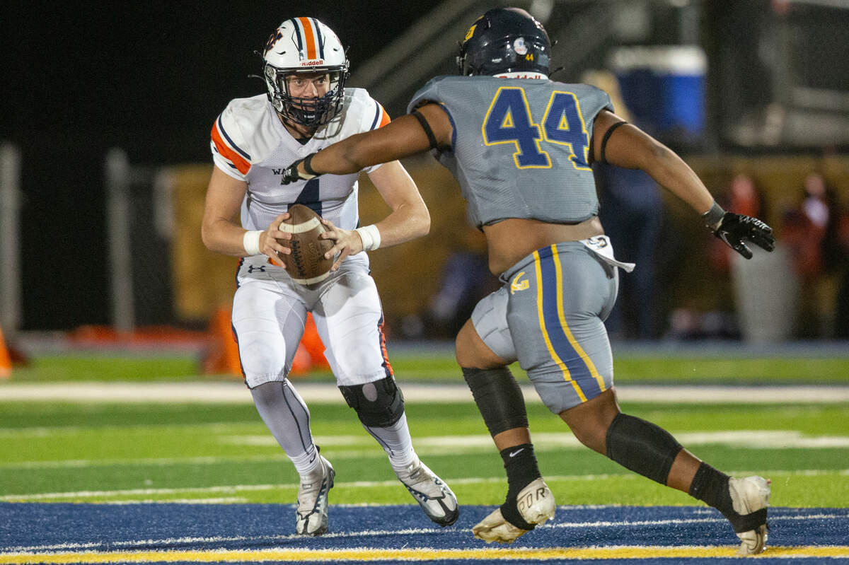 Gautier’s Javonte Robinson heads off Wayne County quarterback Carter Hankins during a playoff game against Wayne County at Gautier High School in Gautier on Friday, Nov. 11, 2022.