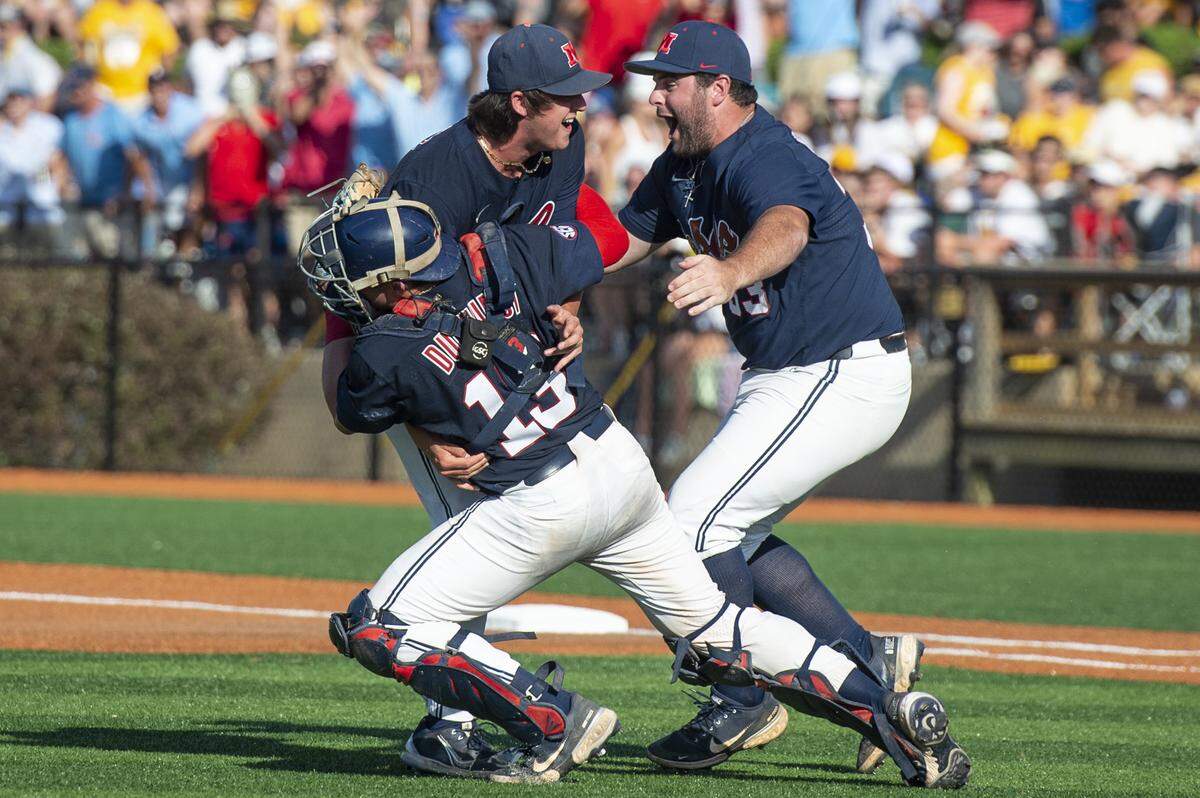 Ole Miss players tackle pitcher Josh Mallitz after winning a shot at the College World Series during the Super Regionals Final at Pete Taylor Park in Hattiesburg on Sunday, June 12, 2022.