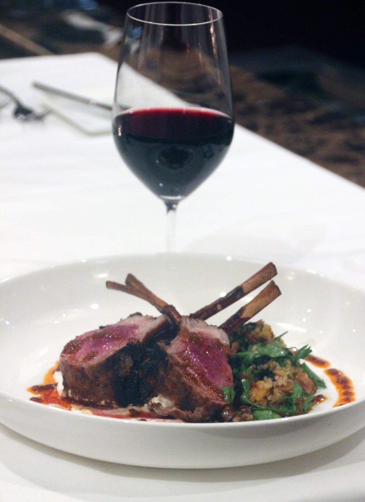 Thirty-Two’s double-cut lamb rack is prepared with apricots, herbs, dates, almonds and roasted carrots for the winter menu at the IP Casino Resort.