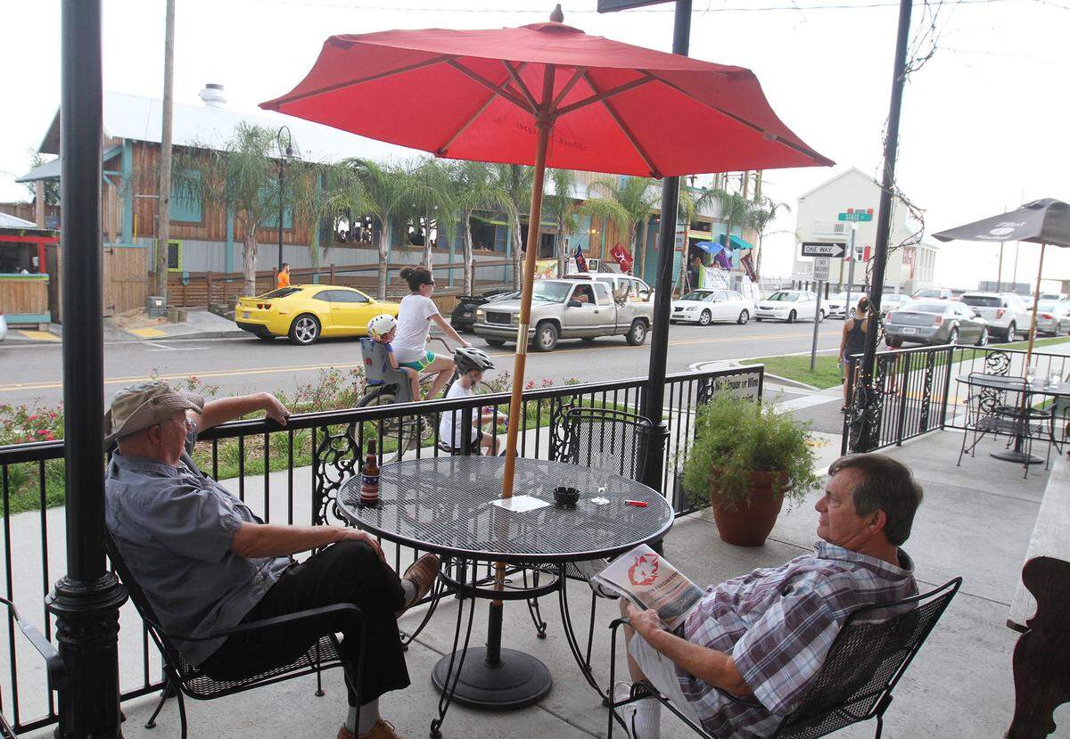 JOHN FITZHUGH/SUN HERALDJim Bosner of Bay St. Louis and Michael Bloom of Waveland relax at 200 North Beach in Bay St. Louis on Sept. 2014. North Beach is in Old Town Bay St. Louis, where a recreation and leisure district could be established allowing visitors to leave restaurants and bars with alcoholic drinks in go cups.