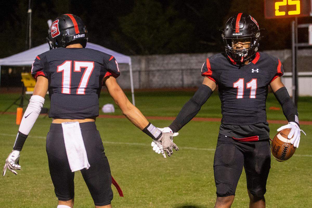 St. Stanislaus’ Chandler Chapman and Levi Green high five after a touchdown during a playoff game against Port Gibson at St. Stanislaus in Bay St. Louis on Friday, Nov. 4, 2022.