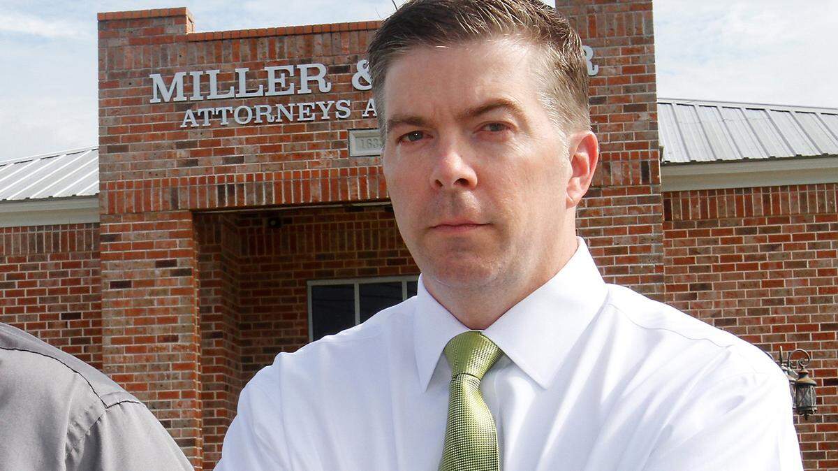 Adam Miller, now suspended from the practice of law for violating rules of conduct for attorneys, stands outside his law office on Wednesday, June 19, 2013.