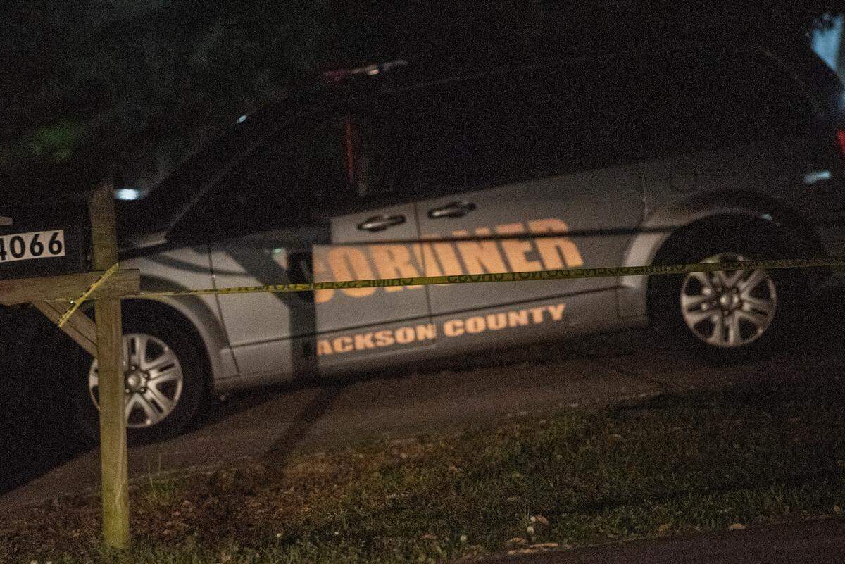 The Jackson County coroner’s car sits in the driveway of a home on Oakview Circle in Latimer on Thursday, April 7, 2022.