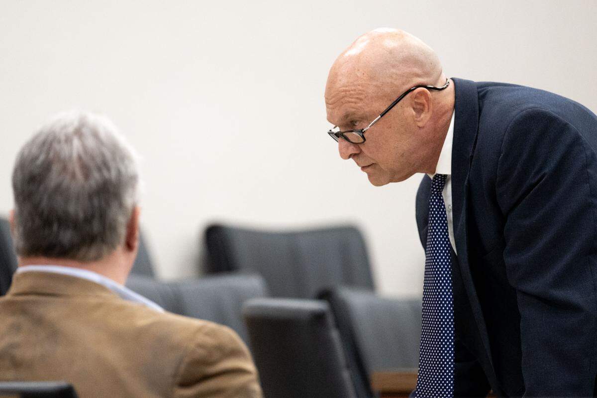 Attorney H.H. “Tracy” Klein III speaks with client Philip Moran during a bond revocation hearing at Harrison County Circuit Court in Biloxi on Friday, March 13, 2026.