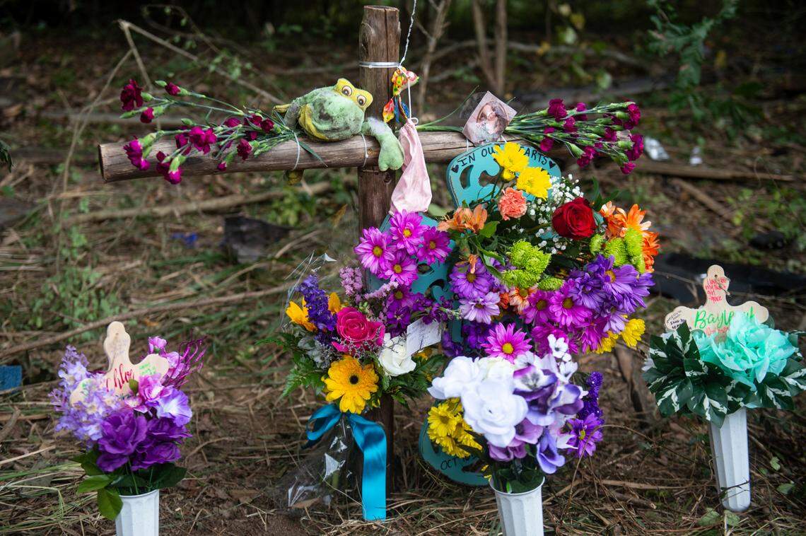 A memorial is set up for Baleigh Bowlin and Chloe Taylor, who were killed in a car accident, at the site of the accident off of Highway 613 in Hurley on Monday, Oct. 17, 2022. Family members found the photo of Chloe’s cousin Beckett, whom she babysat everyday, and stuffed frog among the debris left from the accident.