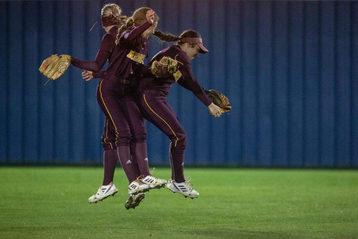 Members of George County’s softball team celebrate in the outfield before the final inning of a game at St. Martin on Monday, March 20, 2023.