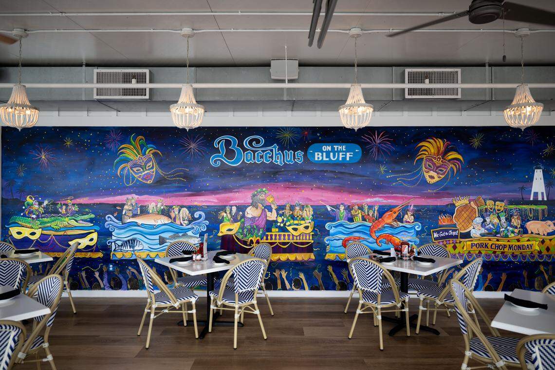 A mural painted by Robert Waldrop depicts Mardi Grad fun on Bernard Bayou in Gulfport. It brightens the wall of the main dining room at the new Bacchus on the Bluff. 