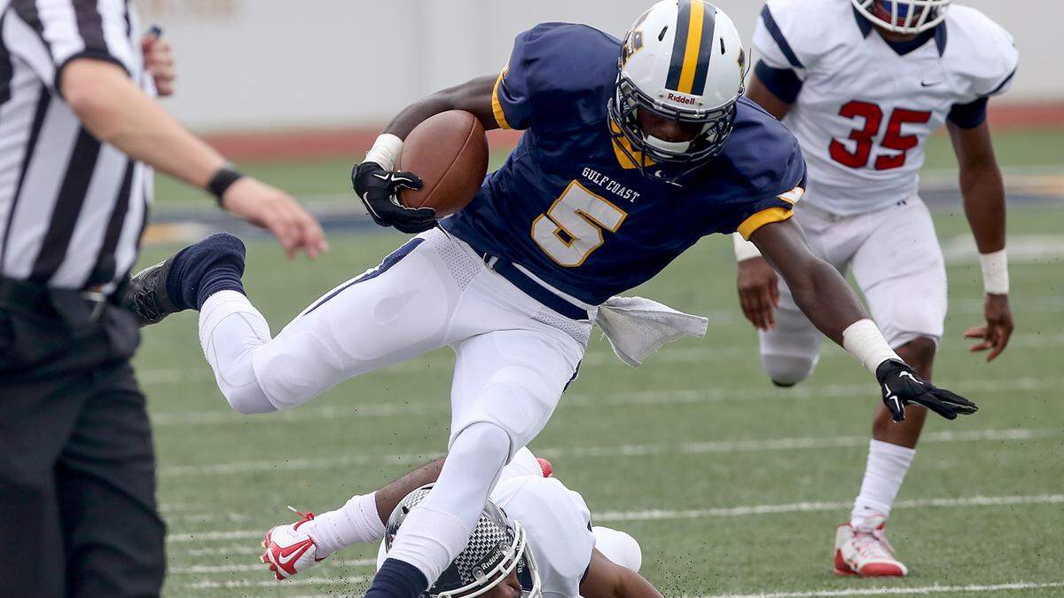 AMANDA McCOY/SUN HERALD 
 Gulf Coast wide receiver Jevon Floyd is pushed out of bounds while competing against Itawamba on Saturday, October 31, 2015. The Bulldogs defeated Itawamba to move on in the MACJC playoffs.