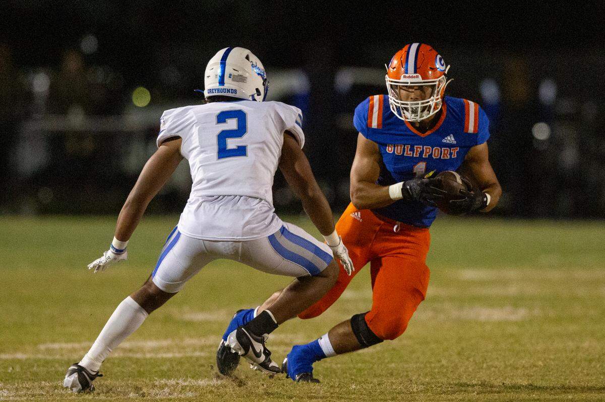 Gulfport’s Cooper Crosby tries to run the ball past Ocean Springs’ Trace Carter during a game against Ocean Springs at Milner Stadium in Gulfport on Friday, Oct. 27, 2023. Ocean Springs beat Gulfport 30-7.