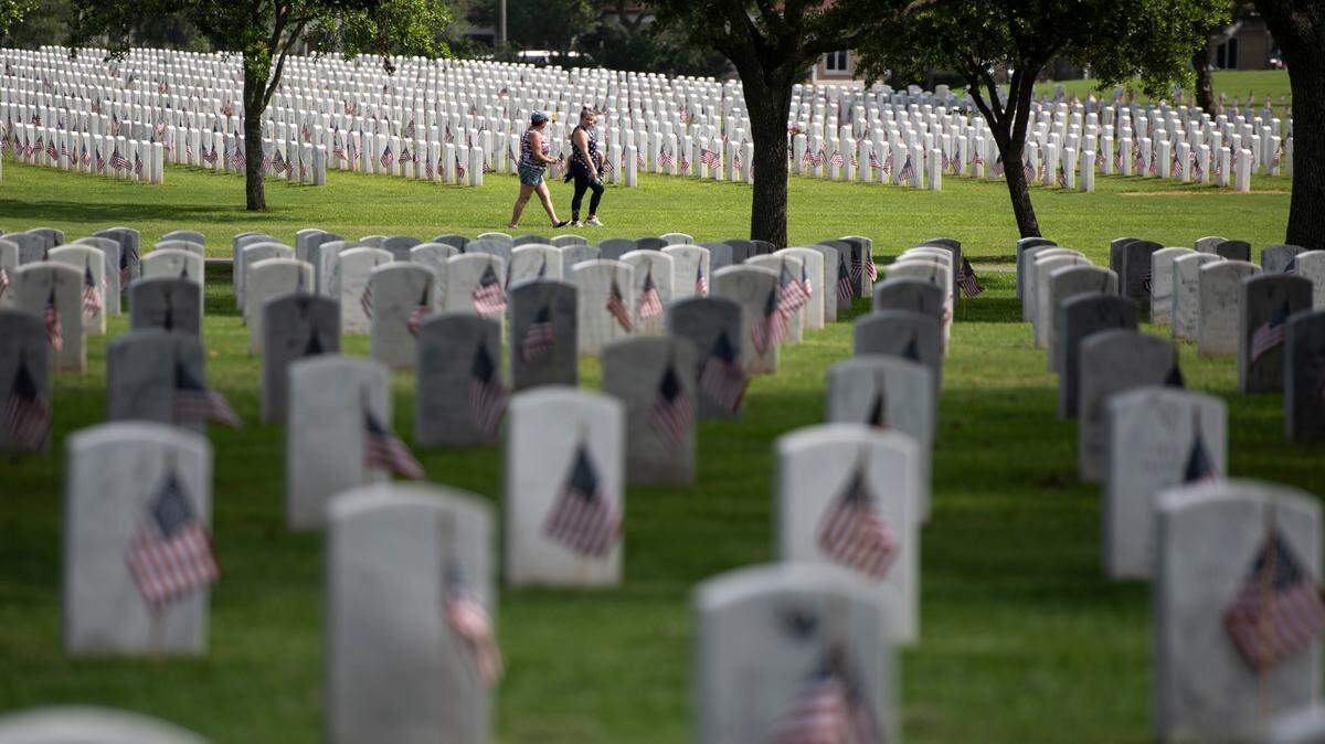 Thousands of tiny American flags decorate the graves of American service members at Biloxi National Cemetery in Biloxi ahead of Memorial Day on Saturday, May 25, 2024.