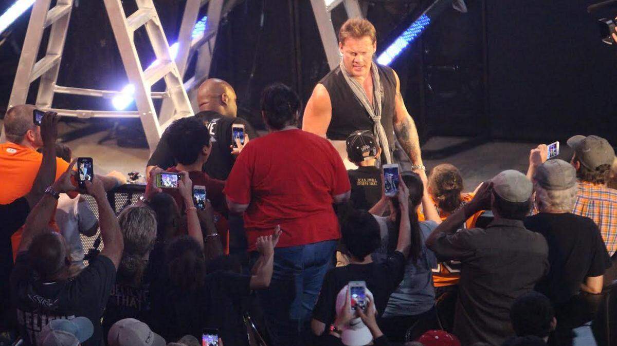 JEFF CLARK/SUN HERALD 
 WWE Wrestler Chris Jericho spots a sign held by Colin Henderson,8, in front of Jericho in the ball cap, that said, "Jericho stinks!" The sign had its intended effect. To Colin's delight, Jericho yanked the sign from the hands of Colin and his baby brother, crumpled it and threw it back at them.