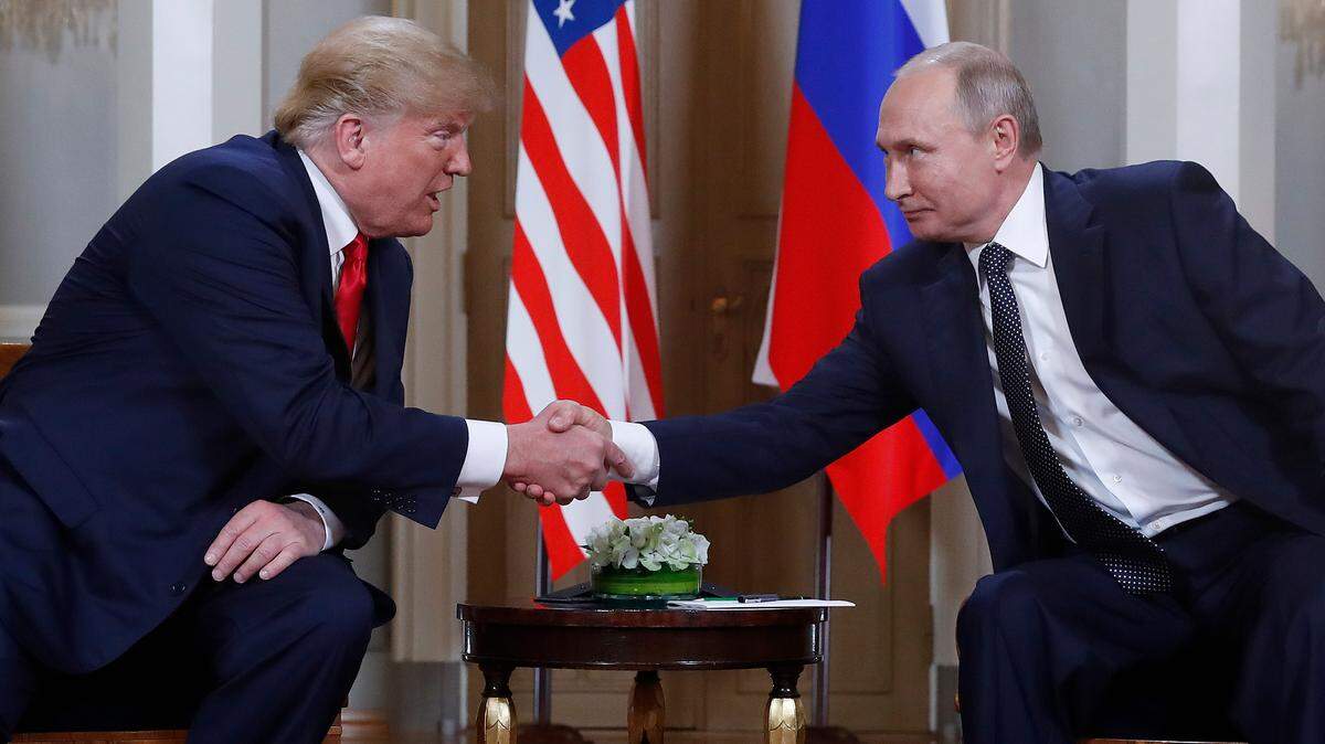 U.S. President Donald Trump, left, and Russian President Vladimir Putin, right, shake hands on July 16 at the beginning of a meeting at the Presidential Palace in Helsinki, Finland.