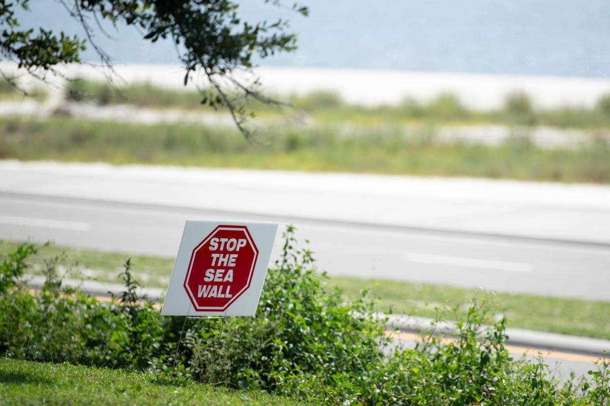 A Stop The Sea Wall sign on Scenic Drive in Pass Christian on Wednesday, Aug. 21, 2024. Some residents banded together in opposition of a boardwalk being build along Highway 90 because they said that city leaders had not shared enough information with the public, the project would ruin their view of the beach and limit beach access.