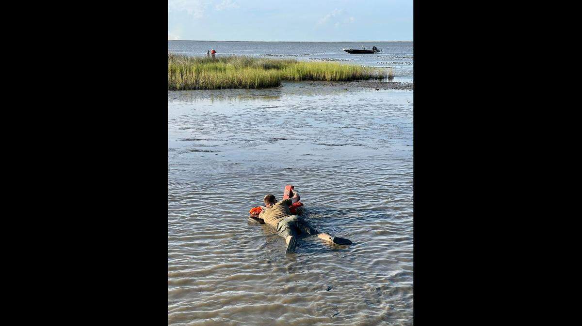 Department of Wildlife and Fisheries Agent Joshua Segrest and others fashioned a raft out of floaties to rescue a married couple whose boat got stuck while fishing in Vermilion Parish, Louisiana.
